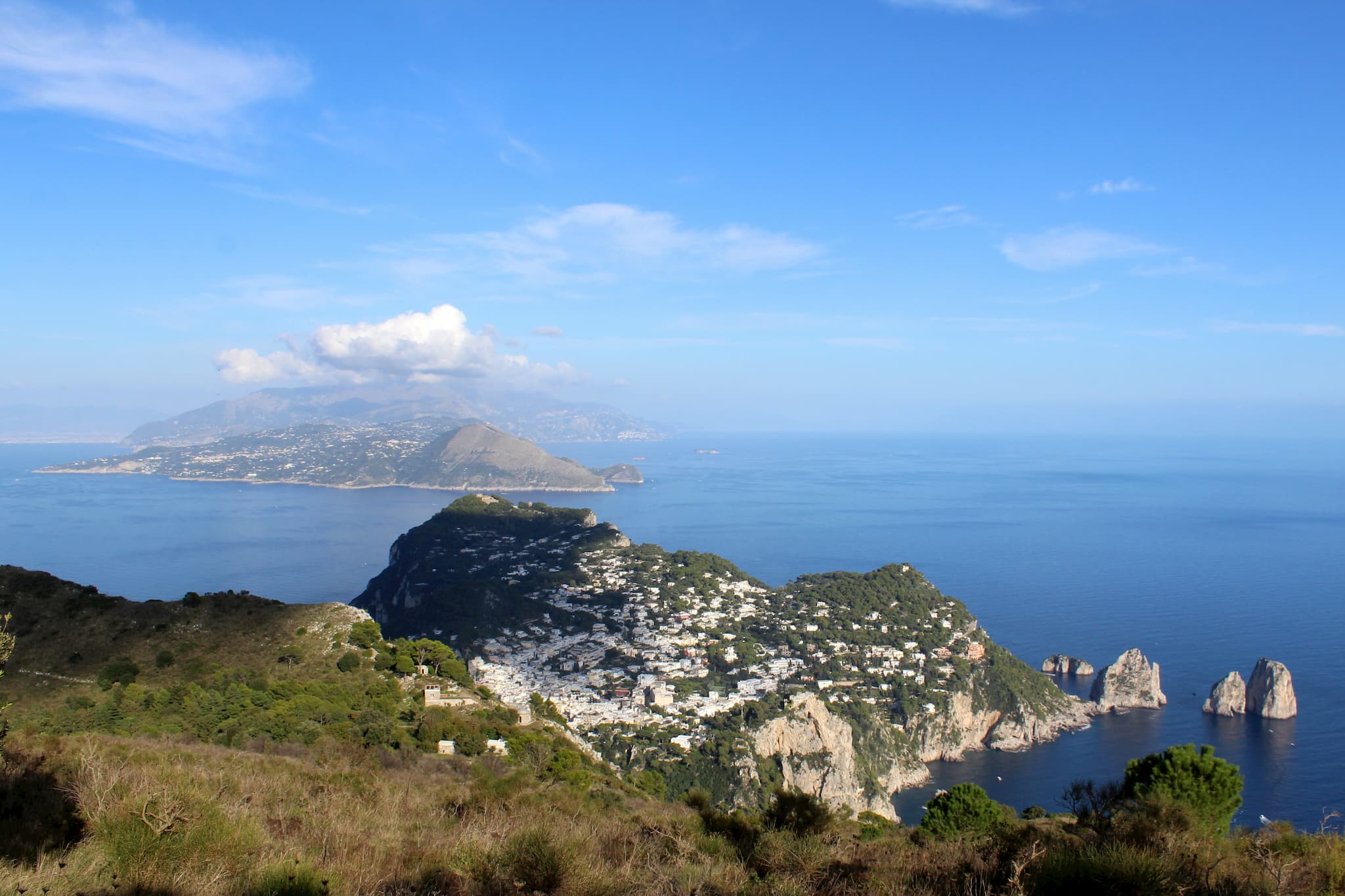 View from high on an island to nearby coast with buildings visible on the island's ridge