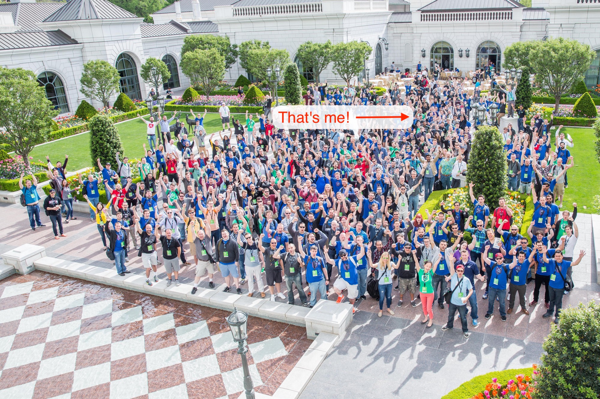 crowd of people in a courtyard, arrow and label on picture saying 'that's me'